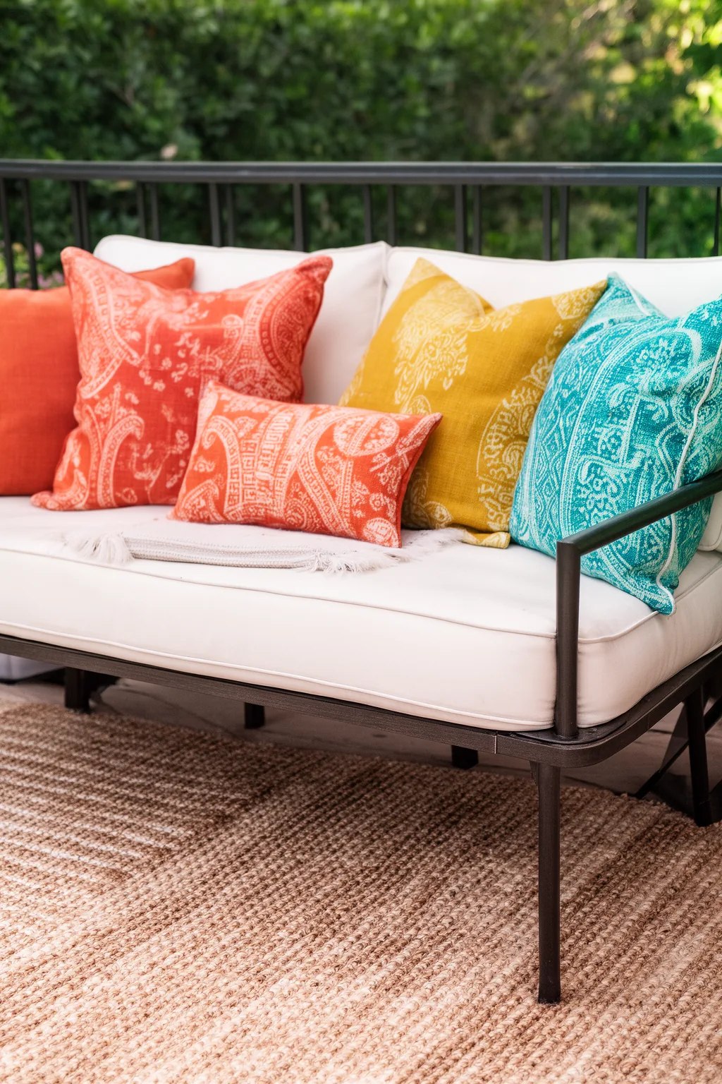 Bold pattern throw pillows on outdoor loveseat