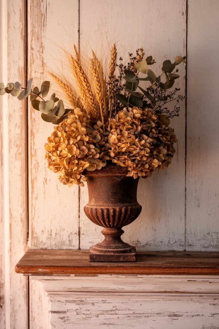 Cast iron urn arrangement on a rustic vintage mantel variation 1