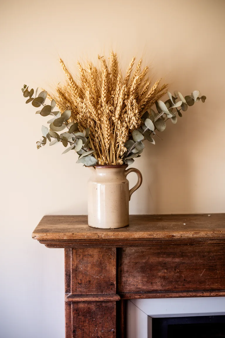 Stoneware pitcher with branches on a rustic vintage mantel variation 5