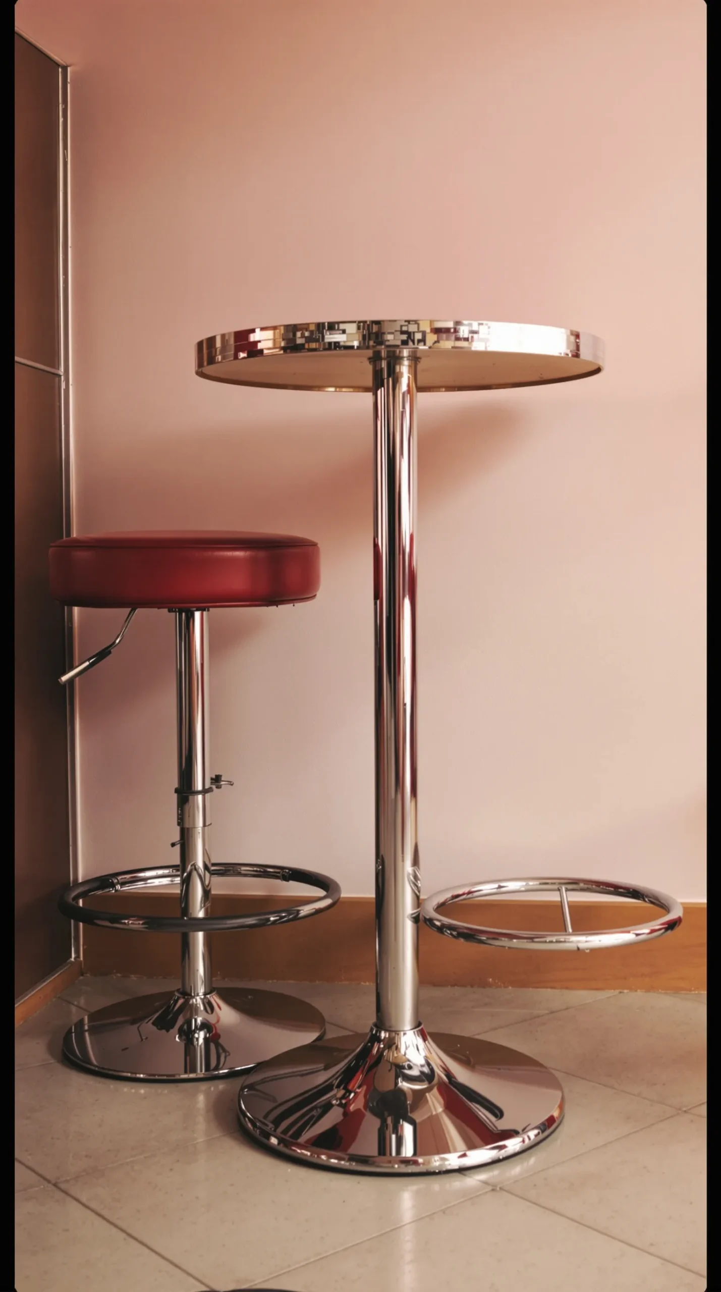 Small chrome bistro table with red vinyl counter stools, retro kitchen
