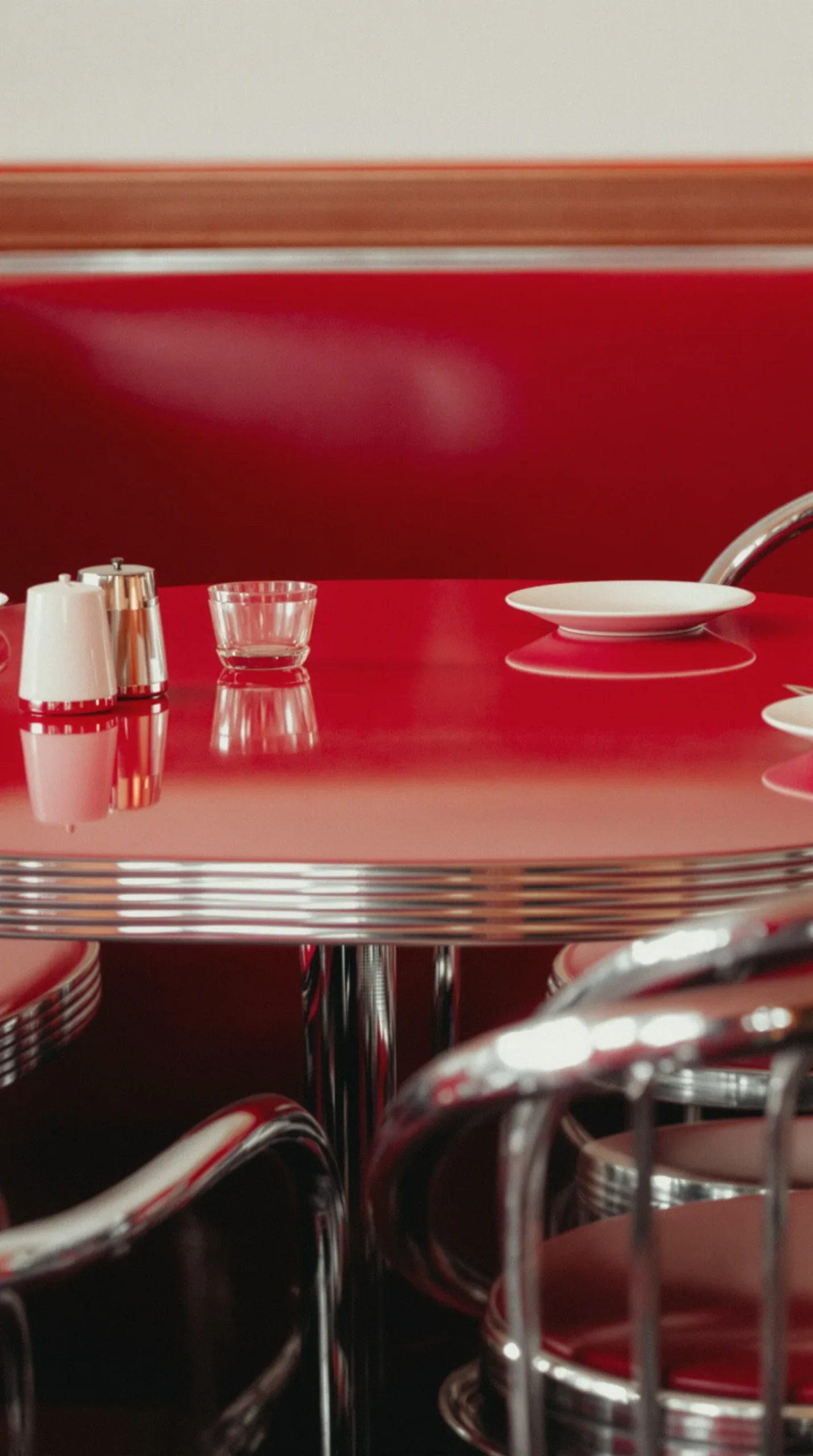 Full retro diner booth and table setup with checkerboard floor