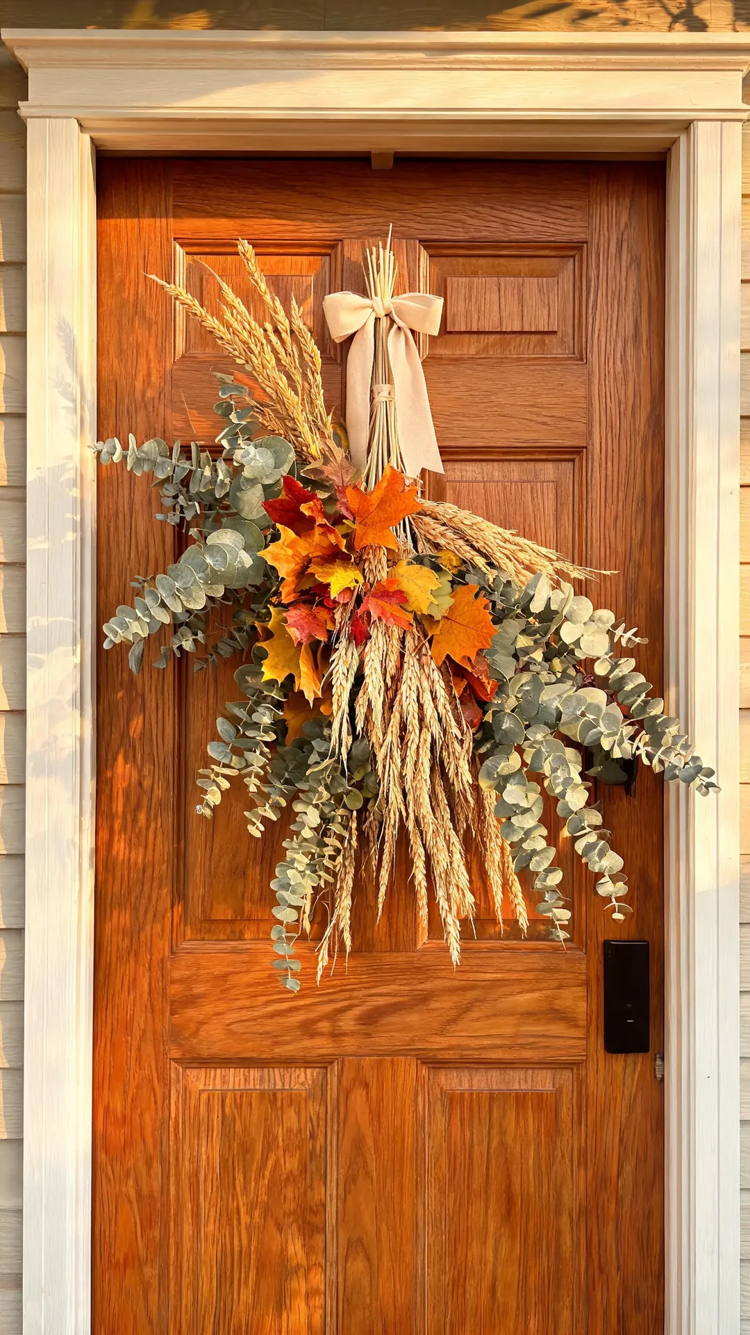 Dried eucalyptus and leaf swag on a front door for fall