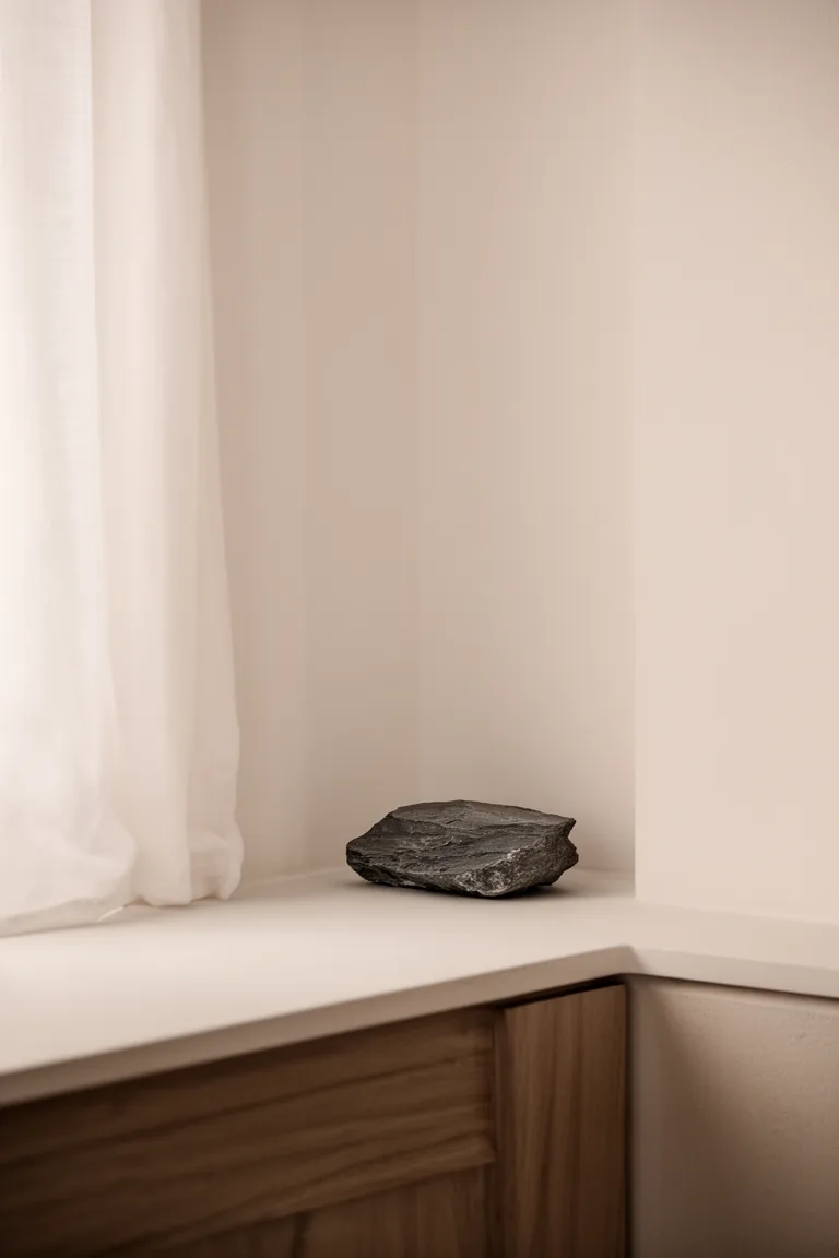 Layered whites with a small slate stone accent for depth