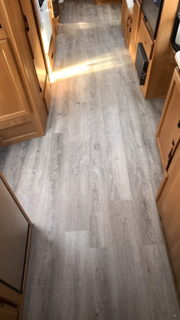 Soft greige grey-wash vinyl flooring for a modern, cozy camper interior