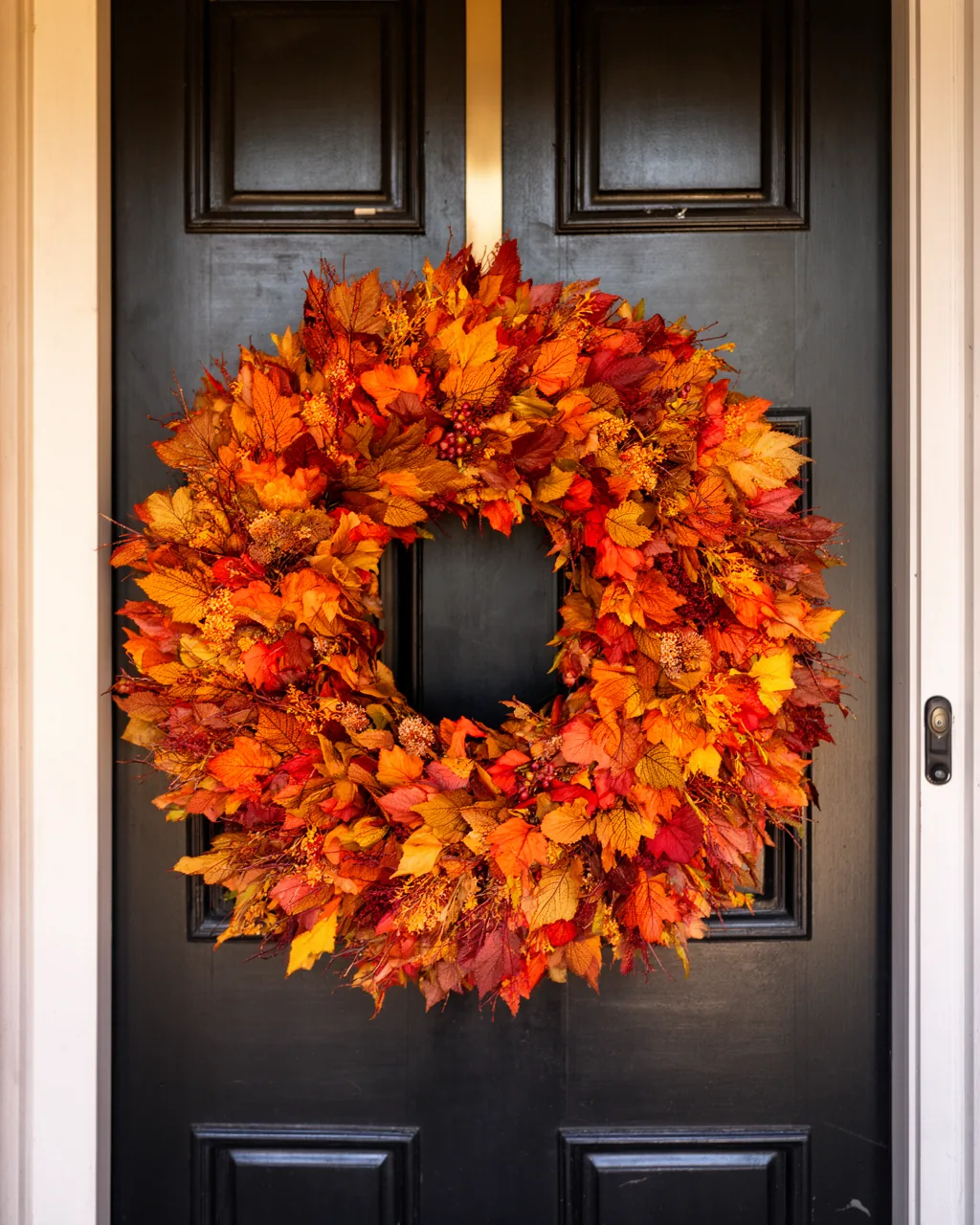 Oversized fall wreath on tall black double doors