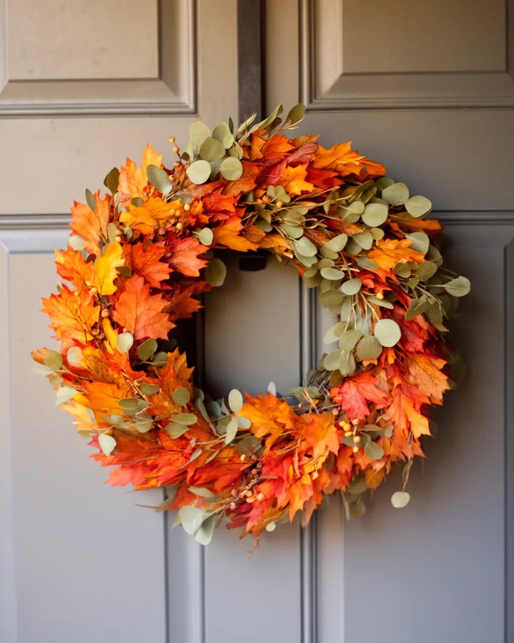 Minimalist eucalyptus ring wreath on a modern gray door