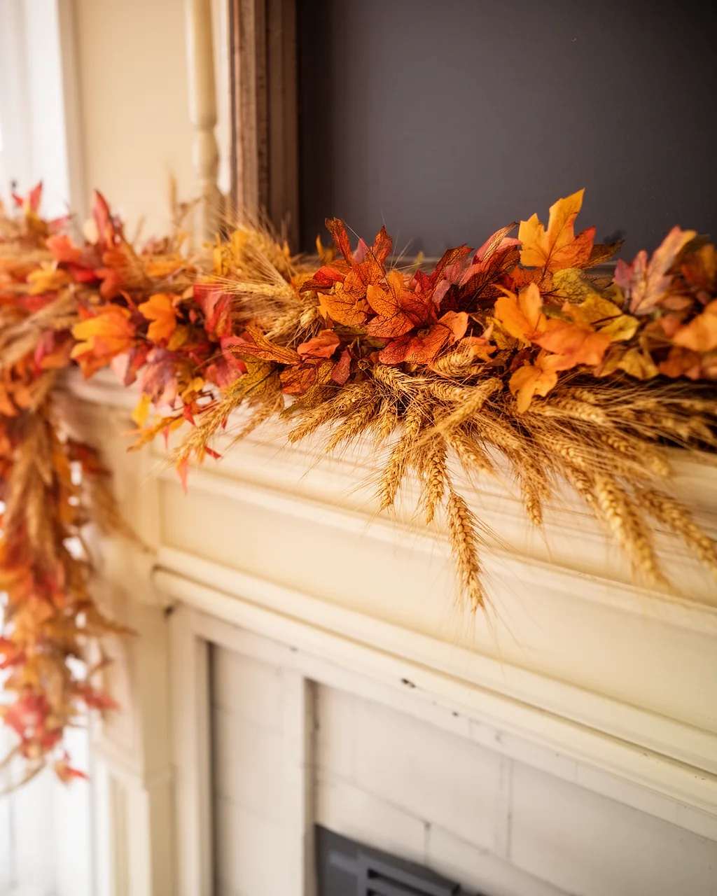 Wheat and dried grass fall garland on a cream mantel