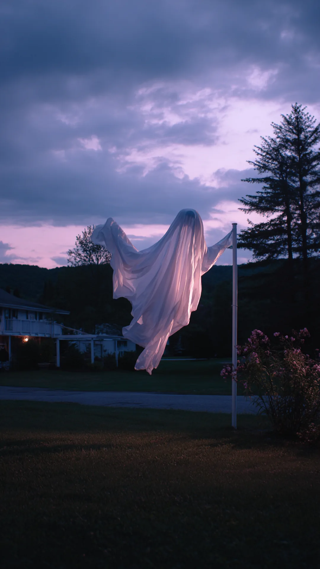 white fabric ghost floating on a pvc frame at dusk — photo 1 of 2