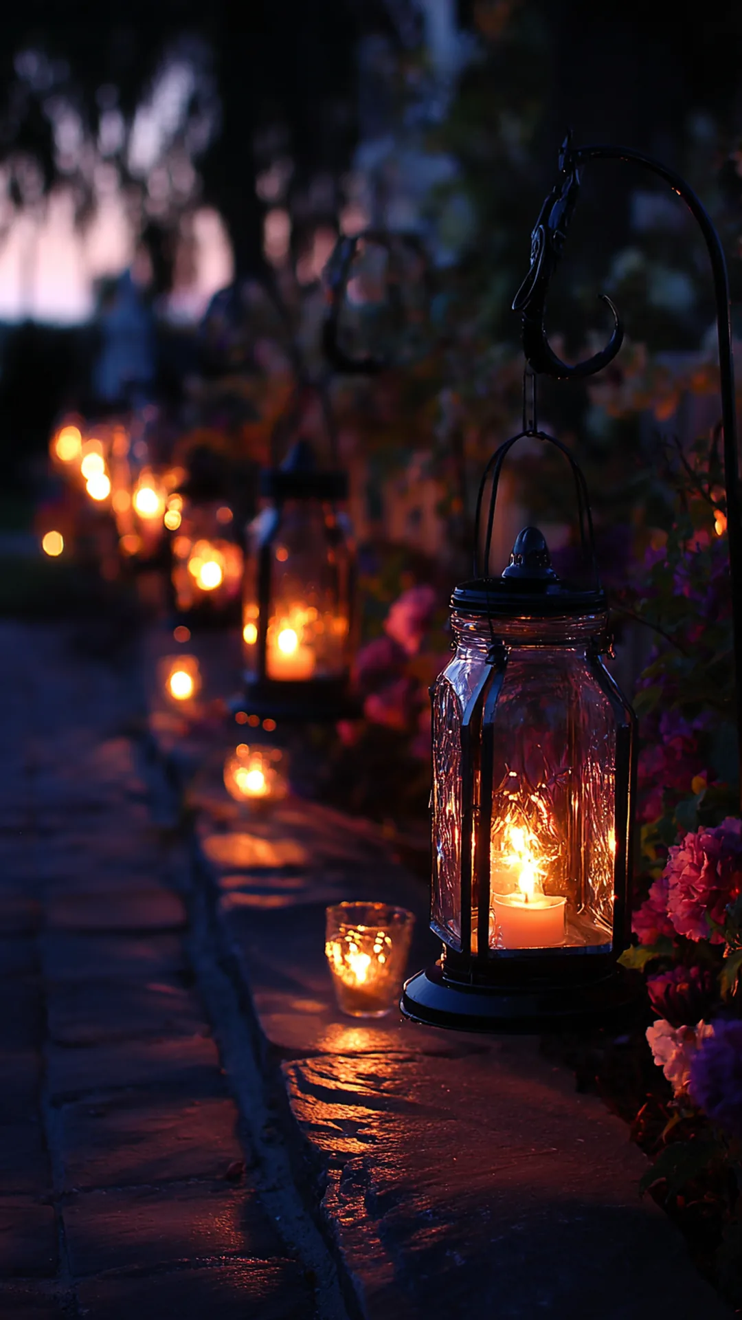 mason jar lanterns hanging from shepherd hooks by a walkway — photo 1 of 2