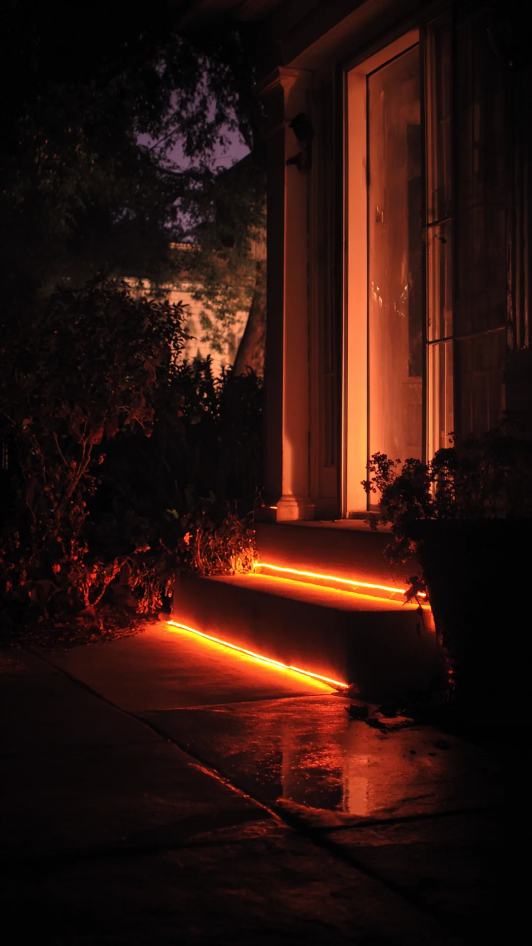 orange rope light outlining a front doorway at night — photo 2 of 2