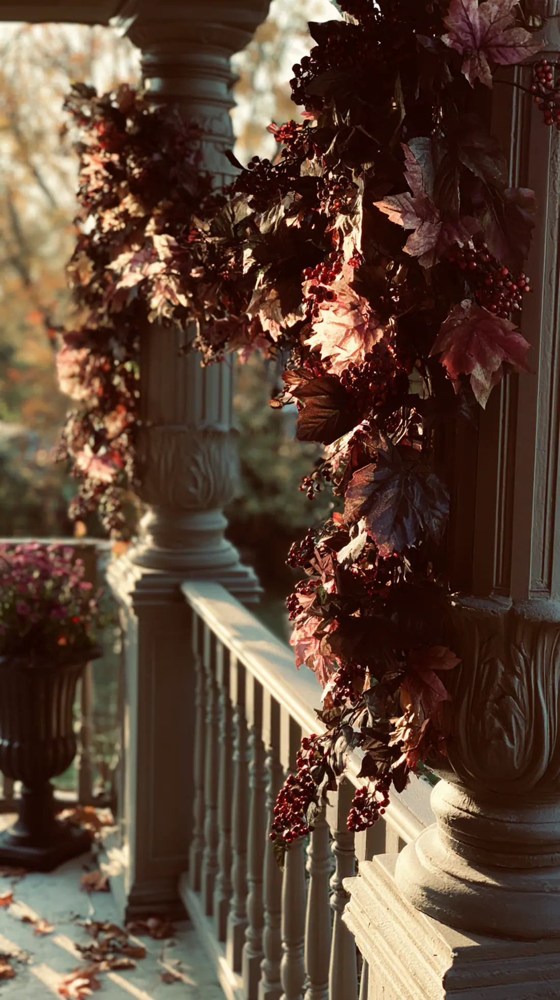 A weighted fall garland swagged along a porch railing between posts, photo 1 of 4