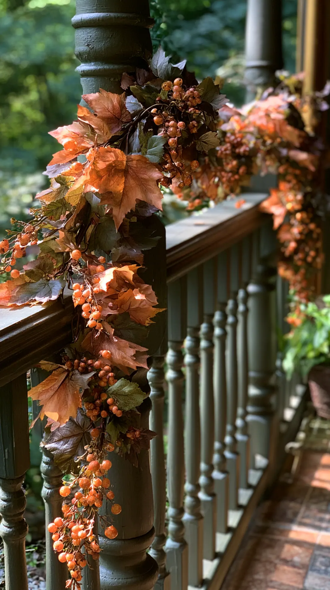 A weighted fall garland swagged along a porch railing between posts, photo 3 of 4