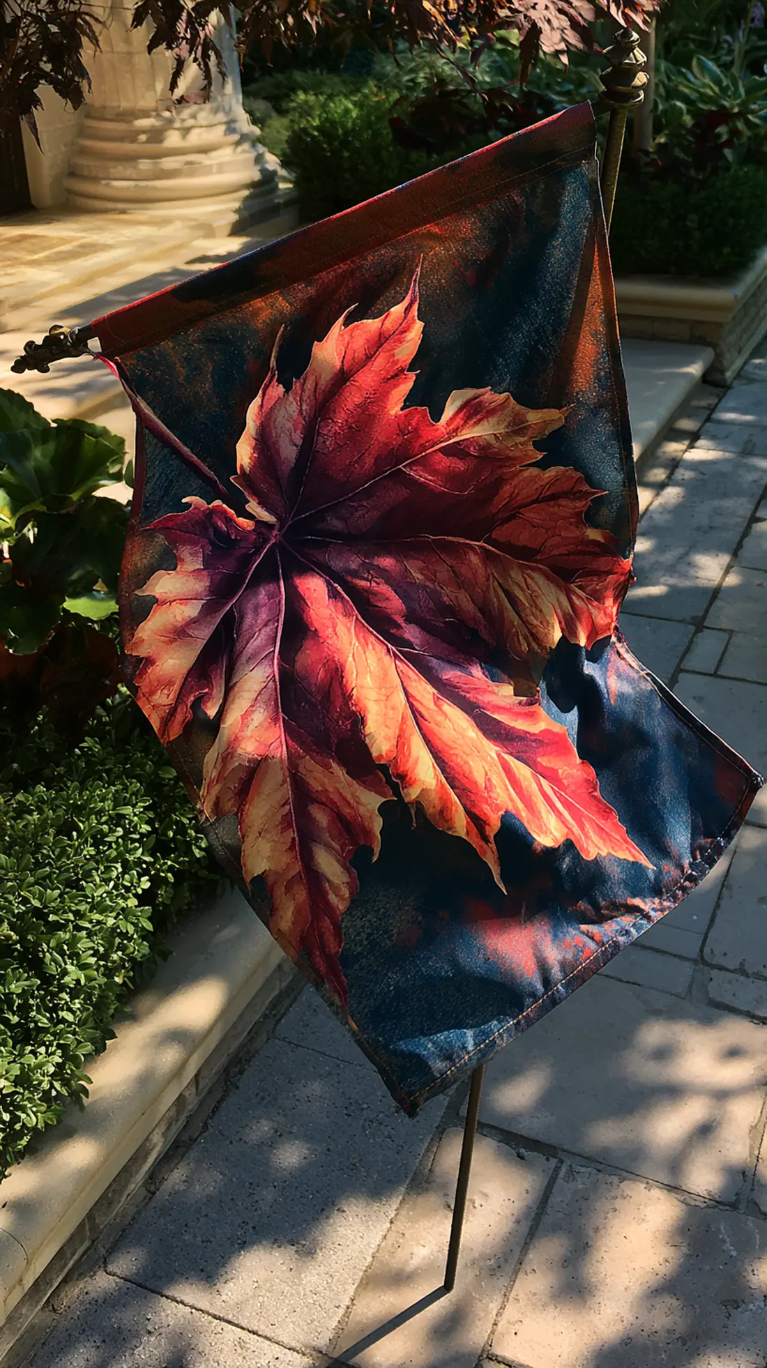 A fall-themed garden flag mounted on a steel ground spike near the front walk, photo 1 of 4