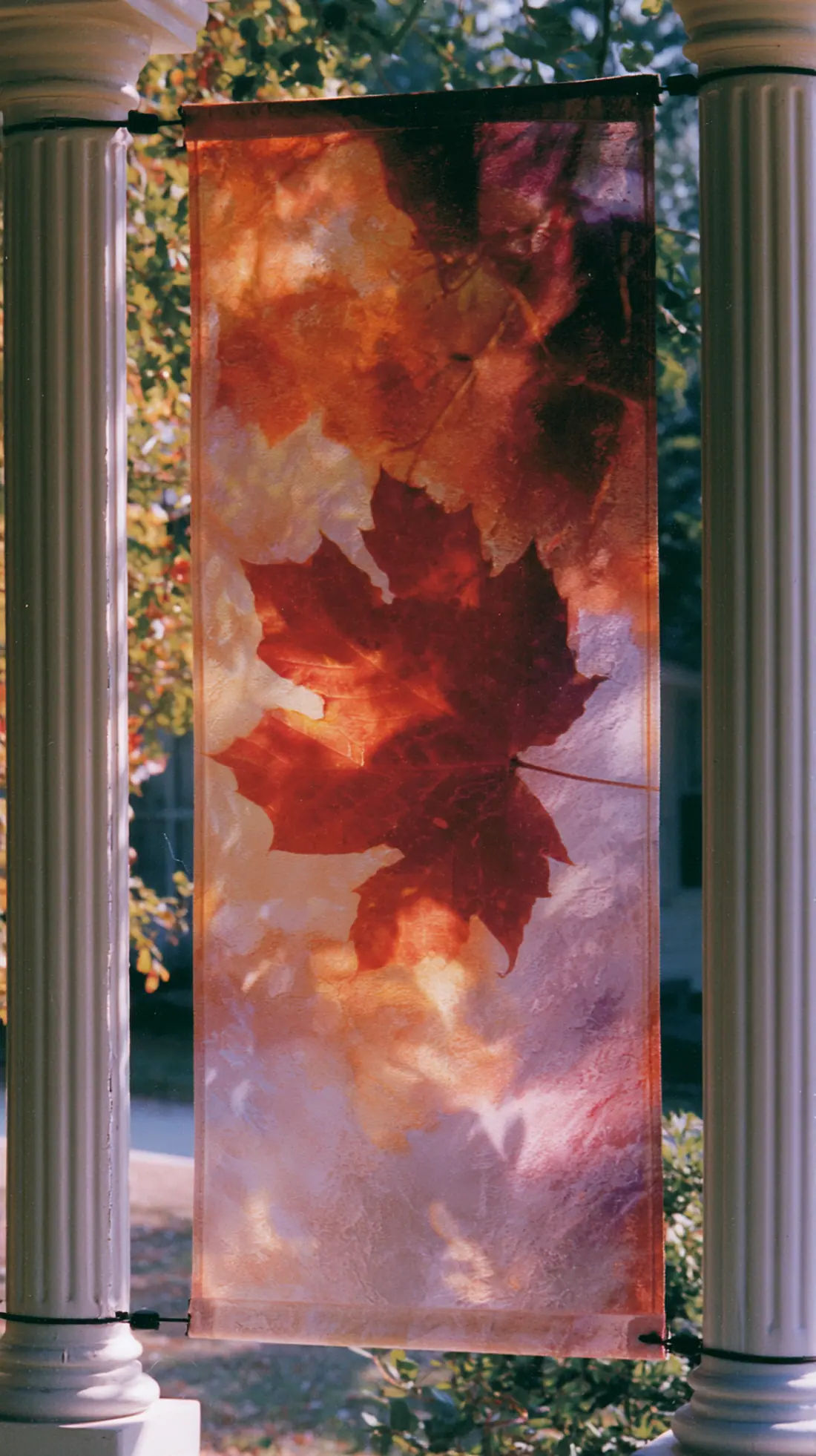 A canvas fall banner secured between two porch posts with zip ties, photo 3 of 4