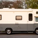 Freshly repainted two-tone camper exterior parked outdoors