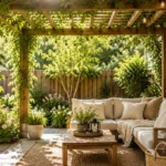Small patio pergola with climbing vines, string lights and a cozy white sofa in a shady backyard retreat