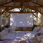 backyard movie-night pergola with a roll-down projector screen and string lights